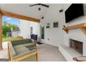 Covered patio with outdoor fireplace, seating, and a view of the backyard at 152 Creekrise Pl, Palmetto, GA 30268
