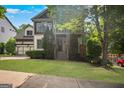 Charming home with mature trees, a covered porch, and a beautifully landscaped front yard at 2548 Kickerillo Se Way, Atlanta, GA 30316