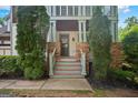 Inviting front entry with stone accents, a dark front door, and lush greenery at 2548 Kickerillo Se Way, Atlanta, GA 30316