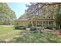 Charming two-story home with a welcoming front porch and beautifully landscaped front yard at 401 Waterwood Bnd, Peachtree City, GA 30269