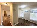 Inviting entryway with wood-look flooring, bright natural light and a view into the spacious living area at 4397 Bluebird Ln, Lithia Springs, GA 30122