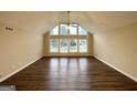 Bright and open living room with vaulted ceilings, expansive windows, and stylish flooring create a welcoming atmosphere at 4397 Bluebird Ln, Lithia Springs, GA 30122