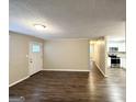 Open-concept living room with wood floors that flows seamlessly into the kitchen at 3332 Ruby H Harper Se Blvd, Atlanta, GA 30354