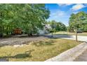Expansive yard featuring a large shed, basketball hoop, and ample space for recreation at 127 Muirwood Dr, Temple, GA 30179
