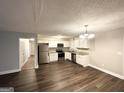 Modern kitchen features stainless appliances, granite countertops, white cabinets, and luxury vinyl plank flooring at 3995 Willowbrook Dr, Douglasville, GA 30135