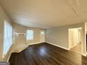 Comfortable living room with luxury vinyl plank flooring, stone fireplace, and large window for ample light at 3995 Willowbrook Dr, Douglasville, GA 30135