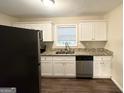 Well-lit kitchen with white cabinetry, granite countertops, and stainless steel appliances at 2610 Preston Dr, Decatur, GA 30034