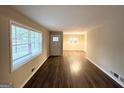 Inviting living area with hardwood floors and natural light from the window and front door at 2610 Preston Dr, Decatur, GA 30034