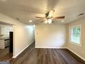 Bright living room featuring hardwood floors, a ceiling fan, and neutral paint at 2930 Waters Rd, Atlanta, GA 30354