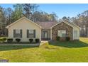 Charming single-story home featuring a stone accent wall and a well-maintained lawn at 425 Wendy Ct, Mcdonough, GA 30252