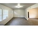 Sunlit living room featuring carpet flooring and neutral paint color at 660 Thomasville Se Blvd, Atlanta, GA 30315