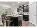 Modern kitchen island with granite countertops and stainless steel appliances at 881 Whittington Sw Pkwy, Marietta, GA 30060