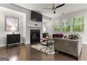 Bright living room featuring hardwood floors, fireplace, and ample natural light at 881 Whittington Sw Pkwy, Marietta, GA 30060