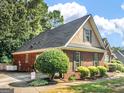 Attractive side view of a brick home, showcasing well-maintained landscaping and curb appeal at 925 Champions Way, Mcdonough, GA 30252