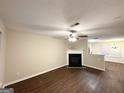 Spacious living room with a fireplace, hardwood floors, ceiling fan and an open floor plan at 263 Coral Cir, Mcdonough, GA 30253