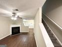 Inviting living room with a fireplace, hardwood floors, and staircase access at 263 Coral Cir, Mcdonough, GA 30253