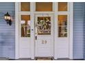 Close up of front door with welcome wreath and sidelights, showcasing the home's entrance at 29 Indian Creek Rd, Locust Grove, GA 30248