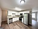 Updated kitchen with stainless steel appliances, granite counters, and white cabinets at 830 Mercury Dr, Atlanta, GA 30331