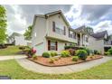 A two-story home showcasing landscaped grounds and a side-entry garage, nestled in a suburban setting at 1484 Stephens Pond Vw, Loganville, GA 30052