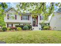 Charming two-story home with a brick front porch and lush landscaping at 1484 Stephens Pond Vw, Loganville, GA 30052