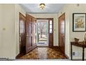 Bright foyer features hardwood floors and a view to the outdoors, with convenient closet space at 55 Helen Ln, Stockbridge, GA 30281