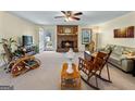 Spacious living room with a brick fireplace and access to the outdoors at 55 Helen Ln, Stockbridge, GA 30281