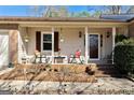 Inviting front porch with rocking chairs and decorative plants creates a cozy entrance at 55 Helen Ln, Stockbridge, GA 30281