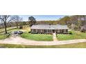 Attractive brick ranch home with a long driveway, scenic landscaping, and ample parking space at 1092 E Lake Rd, Mcdonough, GA 30252