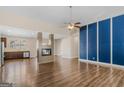 Spacious open-concept living room with hardwood floors, a modern fireplace, and recessed lighting at 1141 Abundance Dr, Locust Grove, GA 30248