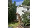 View of back exterior with a set of wooden stairs at 1917 Lake Ridge Ct, Jonesboro, GA 30236