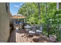 Outdoor deck space complete with comfortable seating, dining area, and views of the surrounding trees at 120 Masters N Dr, Peachtree City, GA 30269