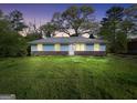 Charming exterior view of a single-story home with blue siding, a brick foundation, and a lush green lawn at 758 King Rd, Jonesboro, GA 30236