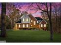 Gorgeous two-story brick home with a manicured lawn in the evening light at 340 Antebellum Way, Fayetteville, GA 30215