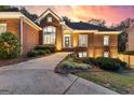 Charming brick home featuring well-kept landscaping, a welcoming entrance, and a curved driveway at 248 Montrose Dr, Mcdonough, GA 30253