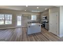 Modern kitchen featuring an island, granite countertops, stainless steel appliances, and gray cabinetry at 746 S. Bethany Rd., Locust Grove, GA 30248