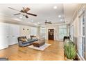 Spacious living room with hardwood floors, recessed lighting, and a comfortable gray sofa and ottoman at 2770 Stonehill Way, Cumming, GA 30041