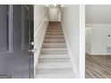 Bright entryway with a carpeted staircase leading upstairs and a modern, open feel at 4282 Worth Nw St, Acworth, GA 30101