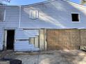 Exterior view showcasing damaged siding and structural issues requiring repair or renovation at 305 Fairburn Nw Rd, Atlanta, GA 30331