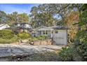 Well-maintained home featuring manicured landscaping, painted brick, and an attached single car garage at 490 E Pharr Rd, Decatur, GA 30030