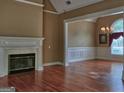 Spacious living room featuring hardwood floors, a fireplace, and abundant natural light at 187 Eagles Club Dr, Stockbridge, GA 30281