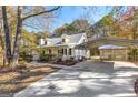 Charming house with metal roof, inviting porch, carport, and well-manicured landscaping at 75 Antioch Rd, Mcdonough, GA 30252