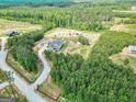 Expansive aerial view showcasing the property's landscaping, pool, and location at 107 Corinth Reserve Pl, Grantville, GA 30220