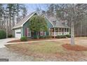 Charming home featuring a two-car garage and inviting front porch at 4186 Highway 138 Sw, Stockbridge, GA 30281
