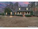 Charming two-story home with a welcoming front porch and mature landscaping at 4186 Highway 138 Sw, Stockbridge, GA 30281