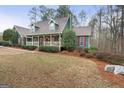 Beautiful two-story home featuring a charming front porch with lovely landscaping at 4186 Highway 138 Sw, Stockbridge, GA 30281