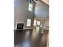 Spacious living room with a fireplace, high ceilings, and beautiful hardwood floors at 606 Gardner Rd, Stockbridge, GA 30281