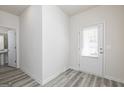 Bright entryway with light wood-look flooring and a white front door with window at 431 Prescott Way, Villa Rica, GA 30180