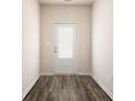 Entryway showcasing a white door with glass panels and dark wood floors, creating an inviting transition space at 442 Prescott Way, Villa Rica, GA 30180