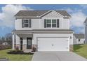 Beautiful two-story home featuring a two-car garage, stone accents, and a well-maintained front yard at 467 Prescott Way, Villa Rica, GA 30180