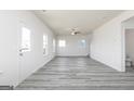 Bright, open living room with gray flooring, white walls, and multiple windows offering natural light at 425 Prescott Way, Villa Rica, GA 30180